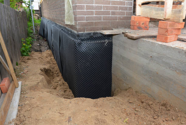 Happy homeowners after waterproofing job in Midway